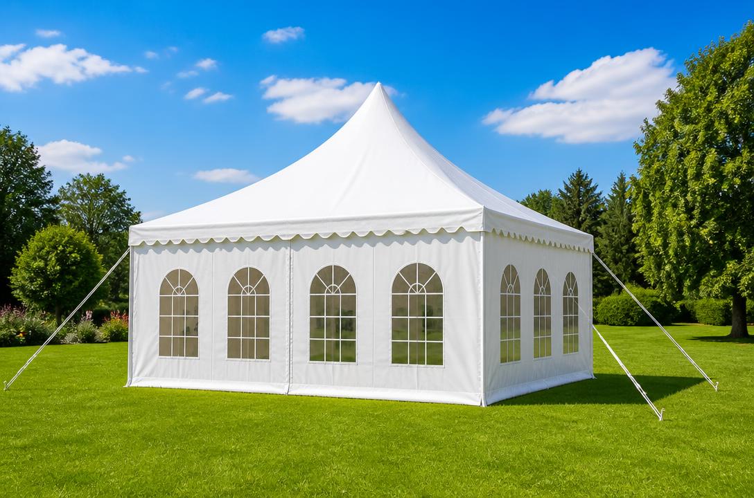 White party tent set up on a sunny green lawn